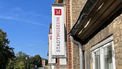 Bild zeigt Banner am Stadtmuseum Schleswig mit dem Aufdruck "Stadtmuseum"