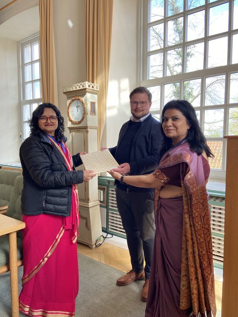 Indische Lehrkräfte Shivani Kaplish und Sonali Gupta von der Mayoor School in Noida mit Bürgermeister Jonas Kähler im Ständesaal überreichen ein Geschenk