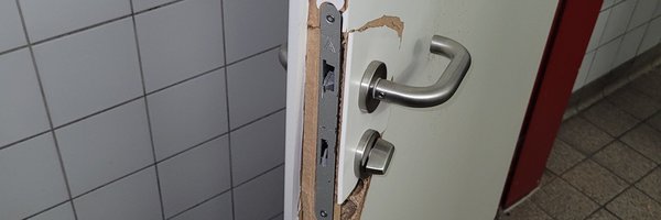 Bild zeigt defekte Toilettentür im Parkhaus aufgrund von Vandalismus