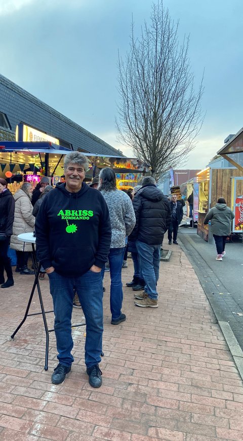Ingo Harder vor einem Getränkeausschank vor dem Parkhaus