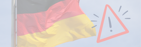 Deutschlandflagge mit Ausrufezeichen im roten Warndreieck